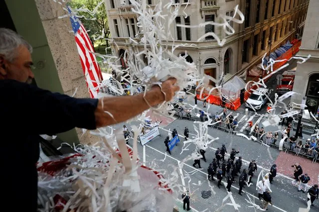People take part in the Hometown Heroes ticker tape parade, to honor essential workers for their work during the outbreak of the coronavirus disease (COVID-19), up New York City's “Canyon of Heroes” in lower Manhattan in New York City, New York, U.S., July 7, 2021. (Photo by Andrew Kelly/Reuters)