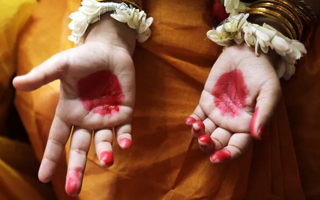 A Hindu girl, her hands decorated with vermillion, participates in a ceremony where young girls are worshipped as “Kumari”, or living goddess, during Ram Navami festival, at a temple in Kolkata, India, Saturday, March 28, 2015. (Photo by Bikas Das/AP Photo)