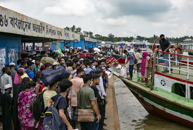 People board a ferry ahead of the Muslim festival of Eid al-Adha on July 20, 2021 in Dhaka, Bangladesh. Bangladesh is in the midst of its worst month of the COVID-19 pandemic, fueled by the Delta variant first detected in India. (Photo by Allison Joyce/Getty Images)