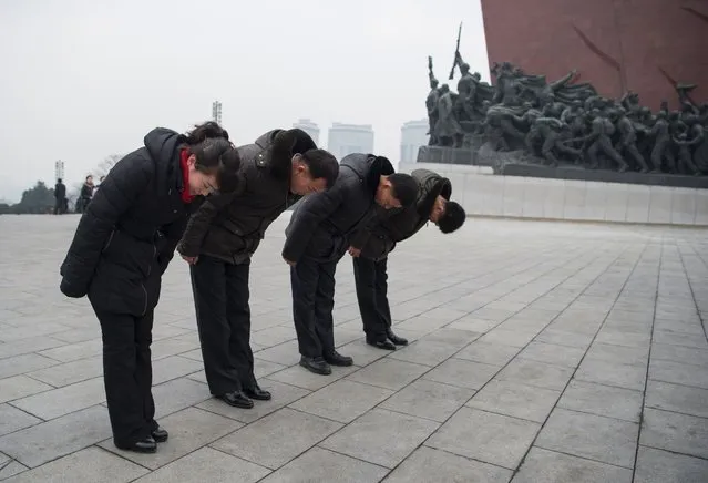 North Koreans bow before statues of former presidents Kim Il-Sung and Kim Jong-Il at the Mansu Hill Grand Monument on New Year's Day in Pyongyang on January 1, 2017. (Photo by Kim Won-Jin/AFP Photo)
