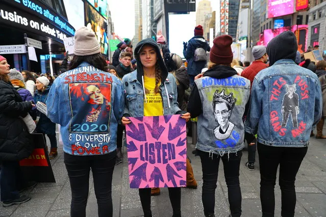 Several young women show off their politically motivated denim jackets in Time Square after participating in the Women’s March in New York City on January 19, 2019 in New York City. (Photo by Gordon Donovan/Yahoo News)