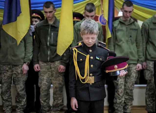 Young military cadets take part in a ceremony to receive their shoulder marks, amid Russia's attack on Ukraine, in Kyiv, Ukraine on November 18, 2022. (Photo by Gleb Garanich/Reuters)