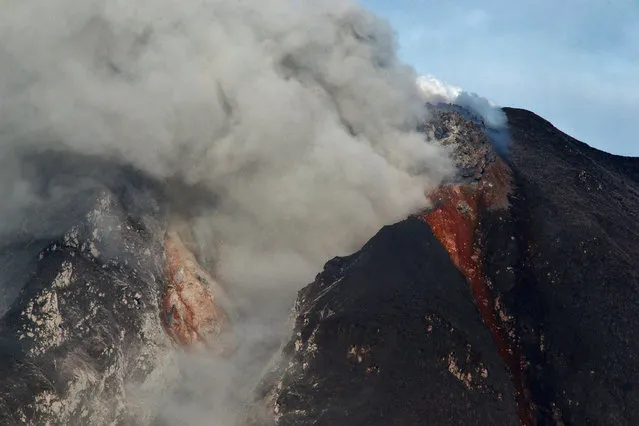 Sinabung mount spews ash and lava during an eruption near from Karo, North Sumatra on January 8, 2014. (Photo by Sutanta Aditya/AFP Photo)
