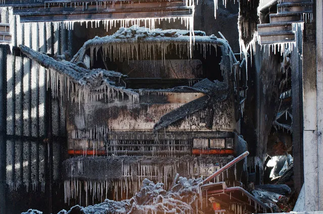Water forms icicles on a truck are seen after a large fire was extinguished by the New York Fire Department (NYFD) during polar vortex in the Brooklyn Borough of New York, U.S., January 31, 2019. (Photo by Lloyd Mitchell/Reuters)