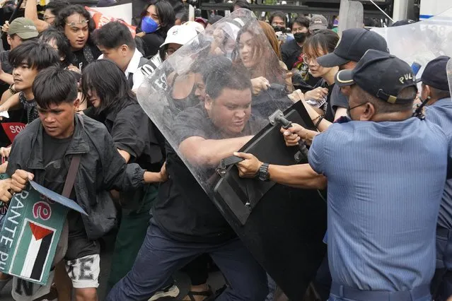 Activists scuffle with police as they tried to march towards the U.S. Embassy to show support with the Palestinian people on November 14, 2023, in Manila, Philippines. (Photo by Aaron Favila/AP Photo)
