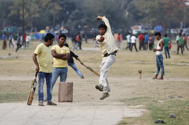 A boy leaps in the air as he bowls while playing cricket in a public park in the old quarters of Delhi, India, March 7, 2016. (Photo by Anindito Mukherjee/Reuters)