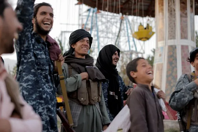 Taliban fighters react as they take a day off to visit the amusement park at Kabul's Qargha reservoir, at the outskirts of Kabul, Afghanistan on October 8, 2021. (Photo by Jorge Silva/Reuters)