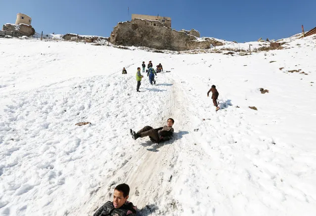 Afghan boys slide down a snow-covered slope in Kabul, Afghanistan February 8, 2017. (Photo by Mohammad Ismail/Reuters)