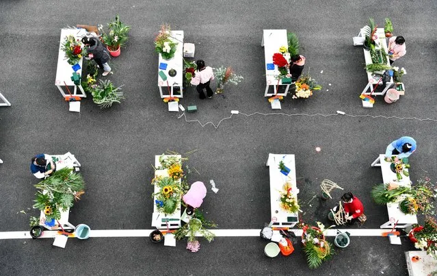 Competitors participate in the contest of flower arrangement during a vocational skills competition in Longli County, southwest China's Guizhou Province, November 23, 2021. (Photo by Xinhua News Agency/Rex Features/Shutterstock)