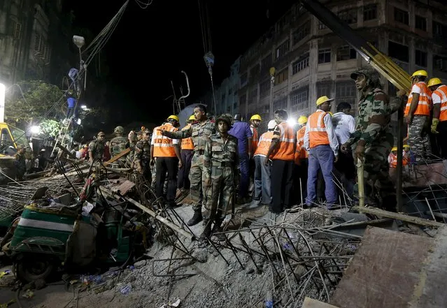 Firefighters and rescue workers search for victims at the site of an under-construction flyover after it collapsed in Kolkata, India, March 31, 2016. (Photo by Rupak De Chowdhuri/Reuters)