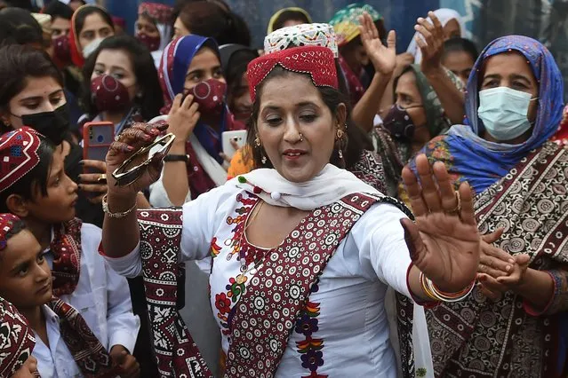 People wearing traditional clothes celebrate the Sindh Cultural Day festival in Karachi on December 5, 2021. (Photo by Rizwan Tabassum/AFP Photo)