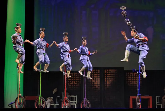 Acrobats perform on stage during the “Shanghai Nights” show of the Chinese National Circus in Brno, Czech Republic on March 20, 2014. (Photo by Radek Mica/AFP Photo)