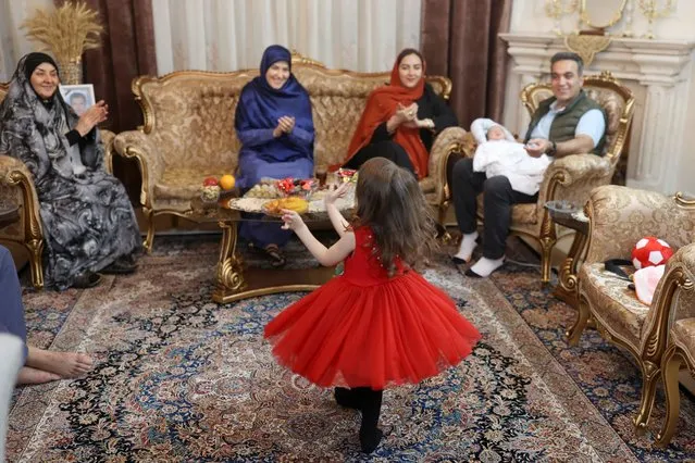 An Iranian family attends a party on the Iranian New Year or Nowruz in Tehran, Iran on March 20, 2024. (Photo by Majid Asgaripour/WANA (West Asia News Agency) via Reuters)