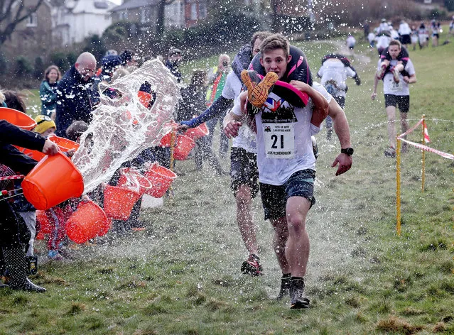 Jack Mckendrick, carrying his partner, Kirsty Jones, wins the 10th UK Wife Carrying Race in Dorking, Surrey, UK on March 5, 2017. (Photo by Gareth Fuller/PA Wire)