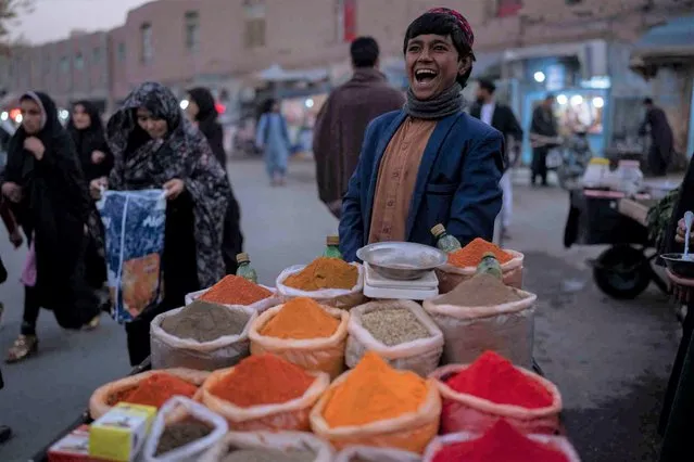 A boy laughs while selling spices in a street market, in Herat, Afghanistan, Thursday, November 25, 2021. (Photo by Petros Giannakouris/AP Photo)