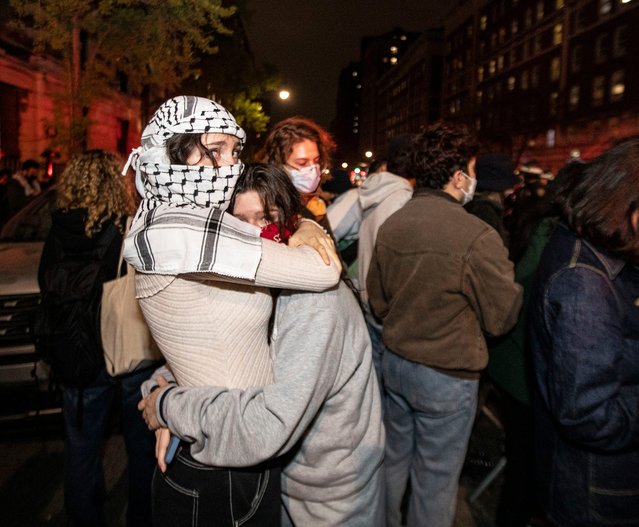 Two people embrace across the street from Columbia University as hundreds of police officers gathered at the university to rid the campus of protesters on April 30, 2024. (Photo by Seth Harrison/The Journal News via USA TODAY Network)
