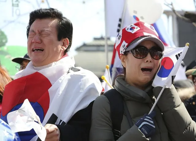 Supporters of South Korean President Park Geun-hye cry during a rally opposing her impeachment near the Constitutional Court in Seoul, South Korea, Friday, March 10, 2017. In a historic ruling Friday, South Korea's Constitutional Court formally removed impeached President Park Geun-hye from office over a corruption scandal that has plunged the country into political turmoil, worsened an already-serious national divide and led to calls for sweeping reforms. (Photo by Ahn Young-joon/AP Photo)
