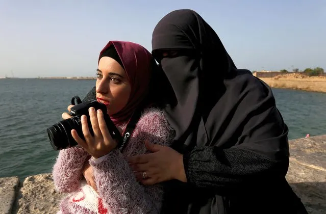 Esaraa Ismail, 22, a visually-impaired photographer who depends on her senses of hearing and touch for photography, is seen with her mother in Alexandria, Egypt, December 7, 2021. (Photo by Hanaa Habib/Reuters)