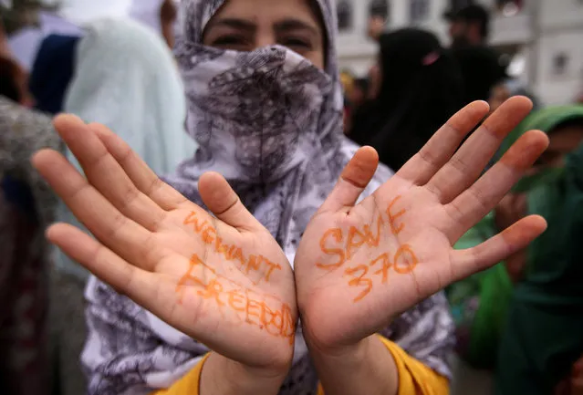 A Kashmiri woman shows her hands with messages at a protest after Friday prayers during restrictions after the Indian government scrapped the special constitutional status for Kashmir, in Srinagar on August 16, 2019. (Photo by Danish Ismail/Reuters)