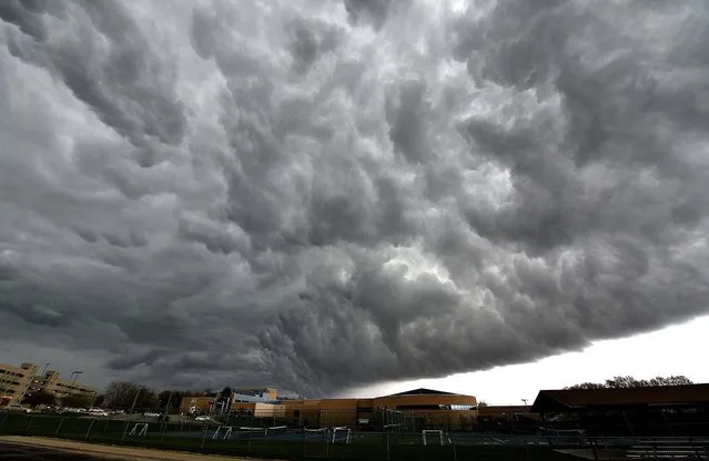 Storm clouds gather over the scene outside the Jewish Community Center in Leawood, Kansas following a shooting, on April 13, 2014. (Photo by John Sleezer/Kansas City Star/MCT)