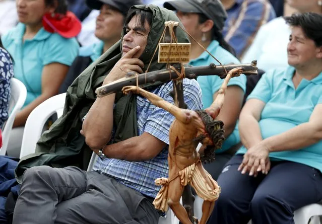 Faithful attend a mass celebrated by Pope Francis at the Bicentenario Park in Quito, Ecuador, July 7, 2015. Thousands of pilgrims braved wind and rain to camp out overnight for a mass to be given by Francis in Ecuador's highland capital Quito for an expected million people. (Photo by Jose Miguel Gomez/Reuters)