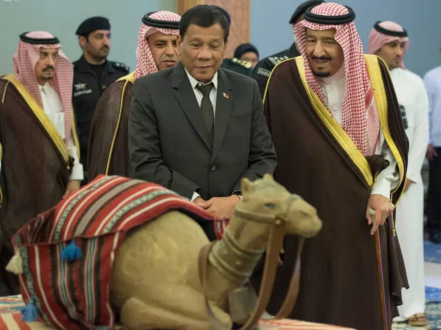 In this photo released by Saudi Press Agency, Saudi King Salman, right, and Philippine President Rodrigo Duterte look at a model of a camel, in Riyadh, Saudi Arabia, Tuesday April 11, 2017. (Photo by Saudi Press Agency via AP Photo)