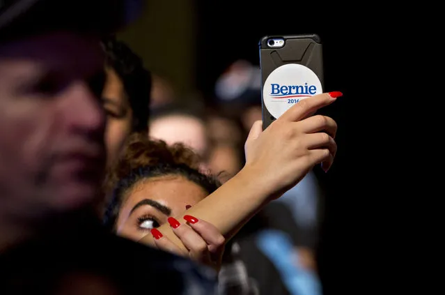 An attendee with a campaign sticker on her phone takes video as Senator Bernie Sanders, an independent from Vermont and 2016 Democratic presidential candidate, not pictured, speaks during a rally at Boardwalk Hall in Atlantic City, New Jersey, U.S., on Monday, May 9, 2016. Atlantic City, the struggling casino hub weeks away from bankruptcy absent state action that has been hit hard by the decline of its dominant industry, is a fitting platform for Sanders populist message on how corporations reap profits while urban areas are neglected. (Photo by Andrew Harrer/Bloomberg)