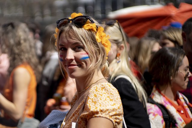 Orange-clad people celebrate King's Day in Amsterdam, Netherlands, Thursday, April 27, 2023. The Netherlands celebrated the 56th birthday of King Willem-Alexander of the House of Orange with street markets, parties and pastries, even as polls showed the monarch's popularity declining. (Photo by Peter Dejong/AP Photo)