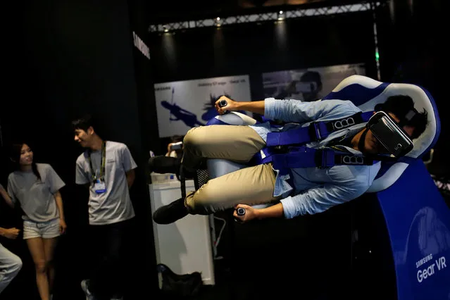 A visitor tries Samsung Gear VR virtual reality headsets during annual Computex computer exhibition in Taipei, Taiwan June 1, 2016. (Photo by Tyrone Siu/Reuters)