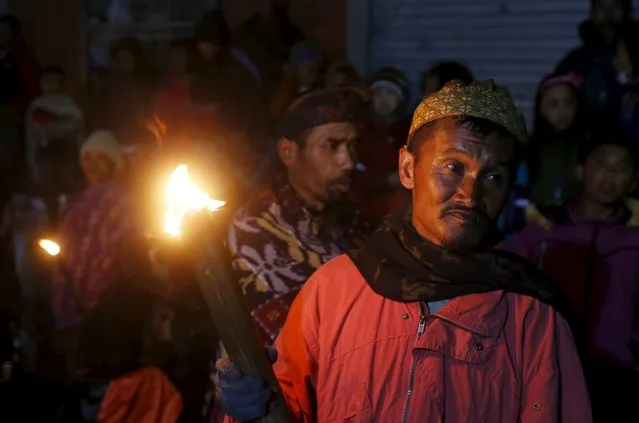 Hindu villagers hold torches during a march ahead of the annual Kasada festival at Ngadisari village near Mount Bromo in Indonesia's East Java province, July 30, 2015. (Photo by Reuters/Beawiharta)