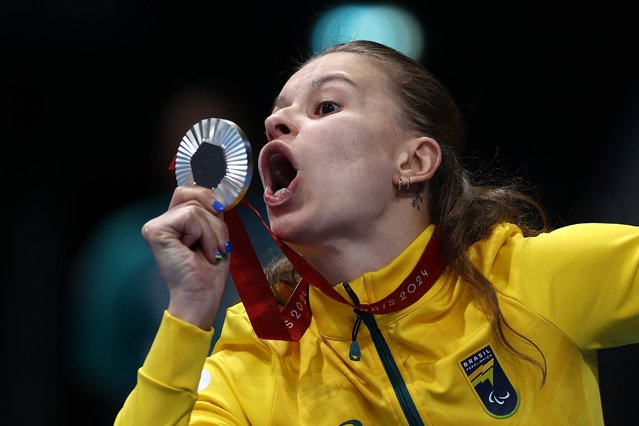 Silver medallist Brazil's Debora Borges Carneiro celebrates during the victory ceremony for the women's SB14 100m breaststroke final event at the Paris 2024 Paralympic Games at The Paris La Defense Arena in Nanterre, west of Paris, on September 02, 2024. (Photo by Franck Fife/AFP Photo)