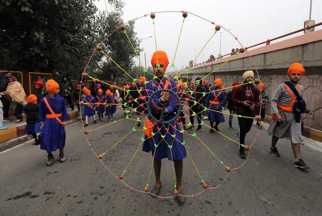 Sikh devotees perform during a religious procession ahead of the birth anniversary of the tenth Sikh Guru, Gobind Singh, in Jammu, India, 30 December 2019. Guru Gobind Singh became leader of the Sikhs at age nine and founded the Sikh warrior community called Khalsa. Sikhs celebrate the Guru's birthday on 02 January annually. (Photo by Jaipal Singh/EPA/EFE)