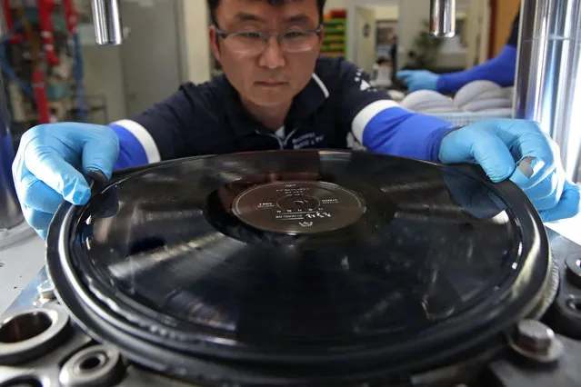 A worker at Machang Music and Pictures produces vinyl records in Seoul, South Korea, 01 June 2017 (reissued 29 June 2017). Japanese tech giant Sony on 29 June 0217 announced it will start again to produce vinyl records, after dropping out from the market some 30 years ago. (Photo by EPA/Yonhap)