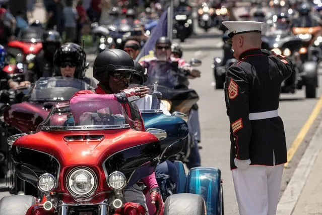 U.S. Marine Corp Staff Sgt. Tim Chambers salutes during the “Rolling to Remember” motorcycle rally, successor to “Rolling Thunder” as it rides through Washington to bring attention to issues faced by veterans, in Washington, U.S., May 29, 2022. (Photo by Ken Cedeno/Reuters)