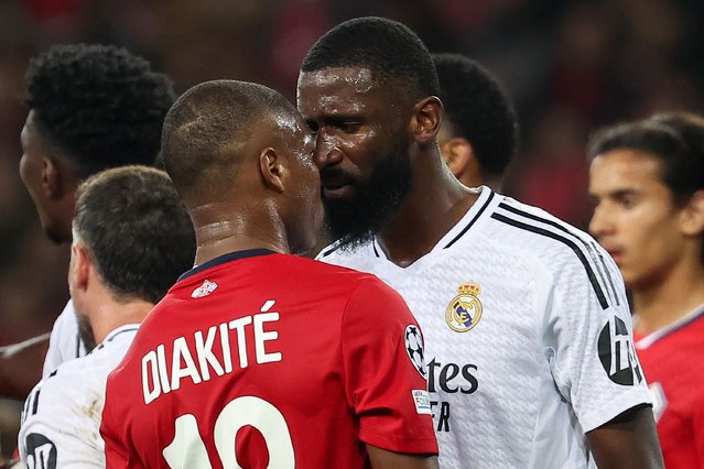 Real Madrid's German defender #22 Antonio Ruediger (R) argues with Lille's French defender #18 Bafode Diakite during the UEFA Champions League football match between Lille LOSC and Real Madrid at the Pierre Mauroy Stadium in Villeneuve-d'Ascq, northern France, on October 2, 2024. (Photo by Franck Fife/AFP Photo)