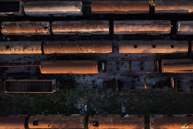 A photo taken with a drone shows abandoned train wagons on old railroad tracks, creating a train graveyard, in Thessaloniki, Greece, 01 October 2024. About 2,000 wagons are exposed to the weather in the Lachanokipi areas, Dialogi, in Nea Ionia, in Aghialos and the Bridge of Thessaloniki. Some of them have been looted, they have become shelters for homeless and marginalized people, they have rusted over time and some of them will be scrapped. (Photo by Achilleas Chiras/EPA)