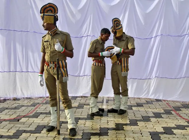 Indian policemen get ready before the start of India's Independence Day celebrations in Kochi, India, August 15, 2015. Indian Prime Minister Narendra Modi's independence day speech focused on measures his "Team India" had rolled out to include millions of poor Indians in the banking and insurance systems, policies for workers and farmers and successes in the fights against inflation and corruption. (Photo by Sivaram V/Reuters)