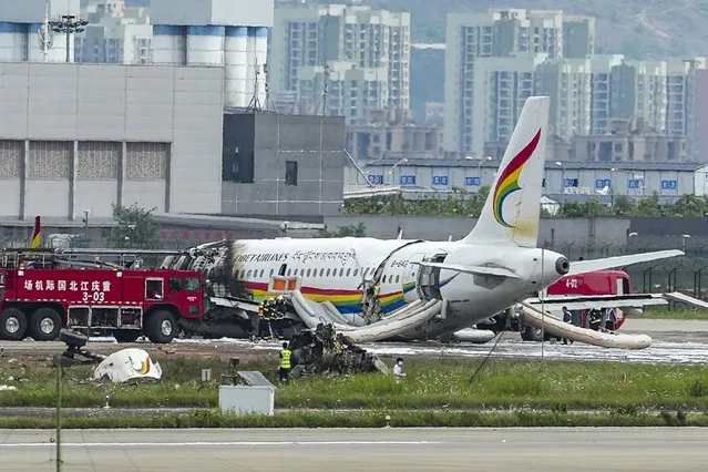 In this photo released by Xinhua News Agency, a passenger jet that veered off a runway during take-off and caught fire is seen in the aftermath in Chongqing Jiangbei International Airport in southwestern China's Chongqing Thursday, May 12, 2022. The Chinese passenger jet left the runway upon takeoff and caught fire in western China on Thursday morning, and several people were injured. (Photo by Liu Chan/Xinhua via AP Photo)