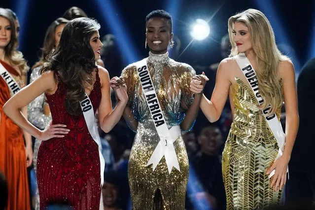 Madison Anderson, of Puerto Rico, Miss Universe 2019 Zozibini Tunzi, of South Africa, and Sofia Aragon, of Mexico, the final three contestants hold hands in the Miss Universe pageant at Tyler Perry Studios in Atlanta, Georgia, U.S. December 8, 2019. (Photo by Elijah Nouvelage/Reuters)