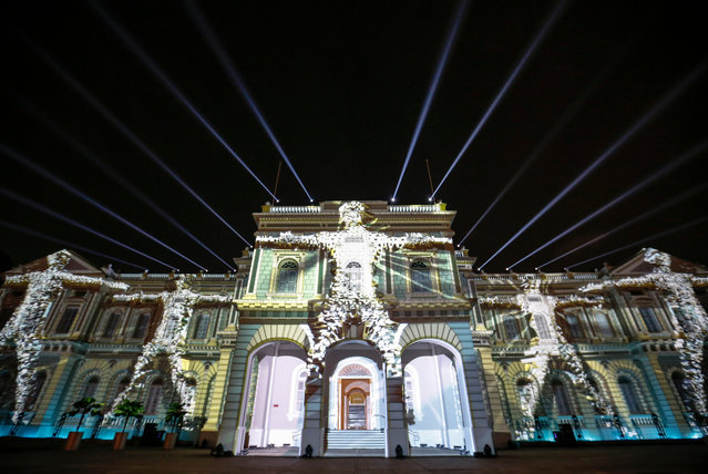 Projections and light beams are displayed on the facade of the National Museum of Singapore titled “Convolutions” by French artist EZ3kiel during a media preview of the Night Festival in Singapore, 16 August 2017. The tenth edition of the Night Festival features installations, light structures, and performances and will run from 18 to 26 August 2017. (Photo by Wallace Woon/EPA)
