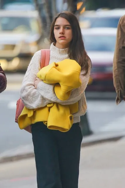 Suri Cruise walks down NYC on March 5, 2020 with her nursemaid by her side and the young daughter of Katie Holmes and Tom Cruise couldn't look more like her parents. (Photo by Backgrid USA)