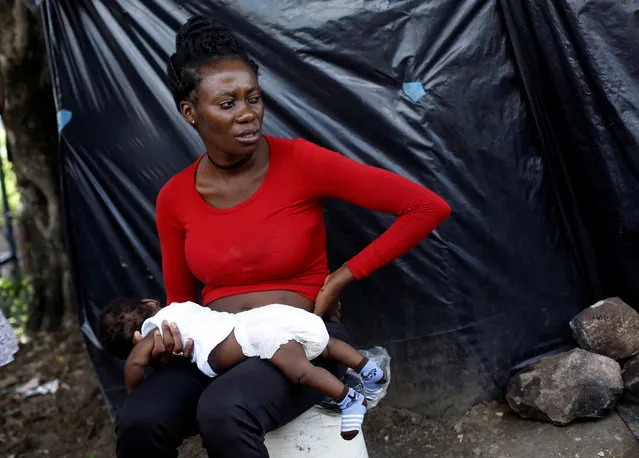 An African migrant stranded in Costa Rica, carries her child at makeshift camp at the border between Costa Rica and Nicaragua, in Penas Blancas, Costa Rica, July 14, 2016. (Photo by Juan Carlos Ulate/Reuters)