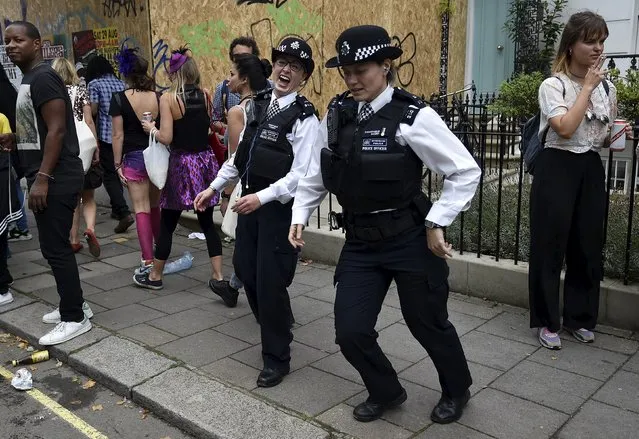 Police officers dance in the street at the Notting Hill Carnival in west London, August 30, 2015. (Photo by Toby Melville/Reuters)