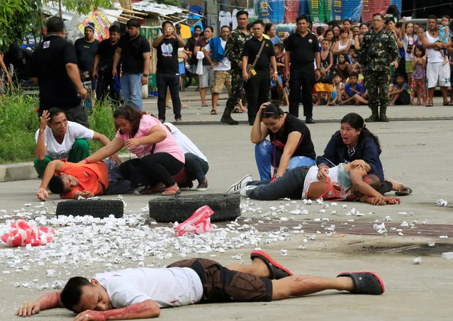 Mock victims shout for help during an earthquake drill as part of the joint capability demonstration of the Philippine Armed Forces' Reserve Command along with other government agencies in observance of national disaster consciousness month in Taguig city, metro Manila, Philippines July 30, 2016. (Photo by Romeo Ranoco/Reuters)