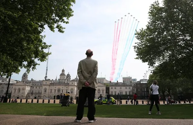 The Royal Air Force Aerobatic Team Red Arrows fly past Horse Guards on the 75th Anniversary of VE Day in London, Britain, May 8, 2020. (Photo by Hannah McKay/Reuters)