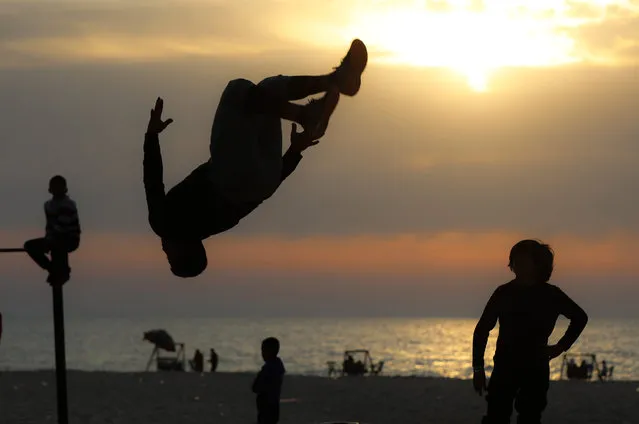 Palestinian youths enjoy their time during sunset at the beach in Gaza City on April 15, 2020. (Photo by Xinhua News Agency/Rex Features/Shutterstock)