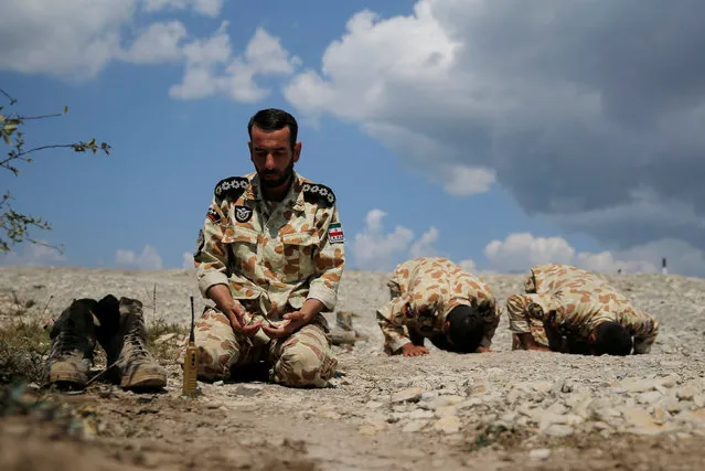 Iranian servicemen pray during the Paratrooper's platoon competition for airborne squads, part of the International Army Games 2016, at the Rayevsky shooting range outside the Black Sea port of Novorossiysk, Russia, August 8, 2016. (Photo by Maxim Shemetov/Reuters)