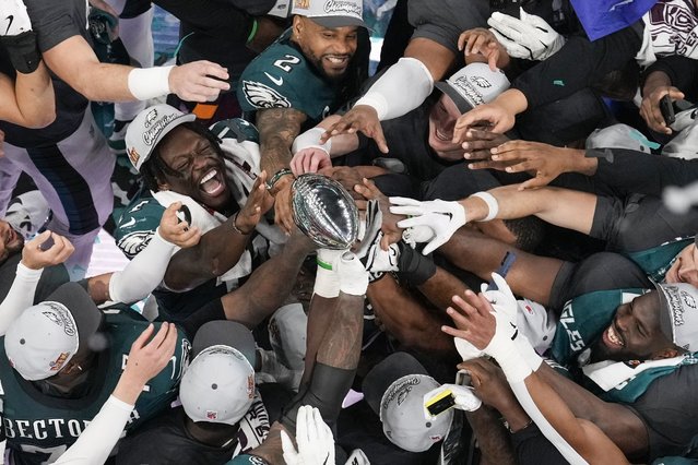 Philadelphia Eagles players celebrate with the Vince Lombardi Trophy after the Eagles won the NFL Super Bowl 59 football game against the Kansas City Chiefs, Sunday, February 9, 2025, in New Orleans. (Photo by David J. Phillip/AP Photo)