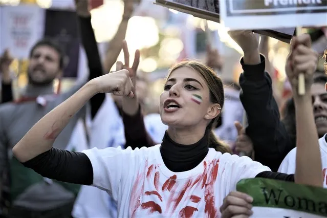 A woman shouts during a protest against the Iranian regime, in Berlin, Germany, Saturday, October 22, 2022, following the death of Mahsa Amini in the custody of the Islamic republic's notorious “morality police”. The 22-year-old died in Iran while in police custody on Sept. 16 after her arrest three days prior for allegedly violating its strictly-enforced dress code. (Photo by Markus Schreiber/AP Photo)