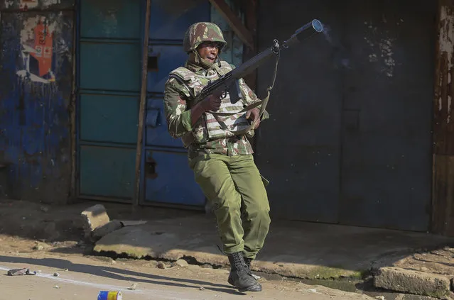 A riot policeman with a tear gas gun during clashes with opposition supporters in Mathare slums in Nairobi, Kenya, Monday, November 20, 2017 after Kenya's Supreme Court on Monday upheld President Uhuru Kenyatta's re-election in a repeat vote that the opposition boycotted while saying electoral reforms had not been made. The decision appeared to put an end to a months-long political drama never before seen in Africa that has left dozens dead. (Photo by Brian Inganga/AP Photo)